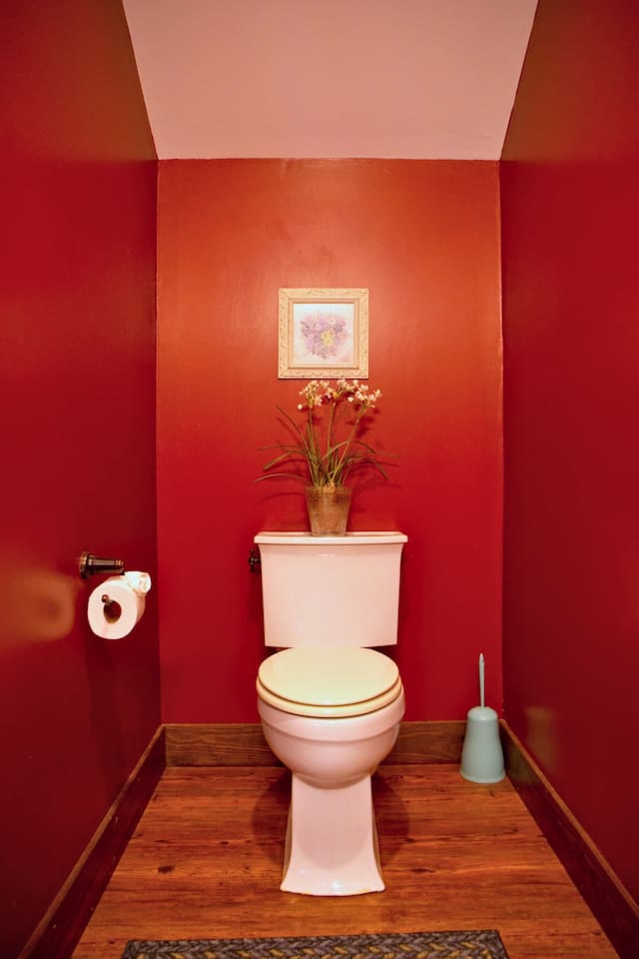 The half bath, located across from the kitchen, includes a pedestal sink and toilet.