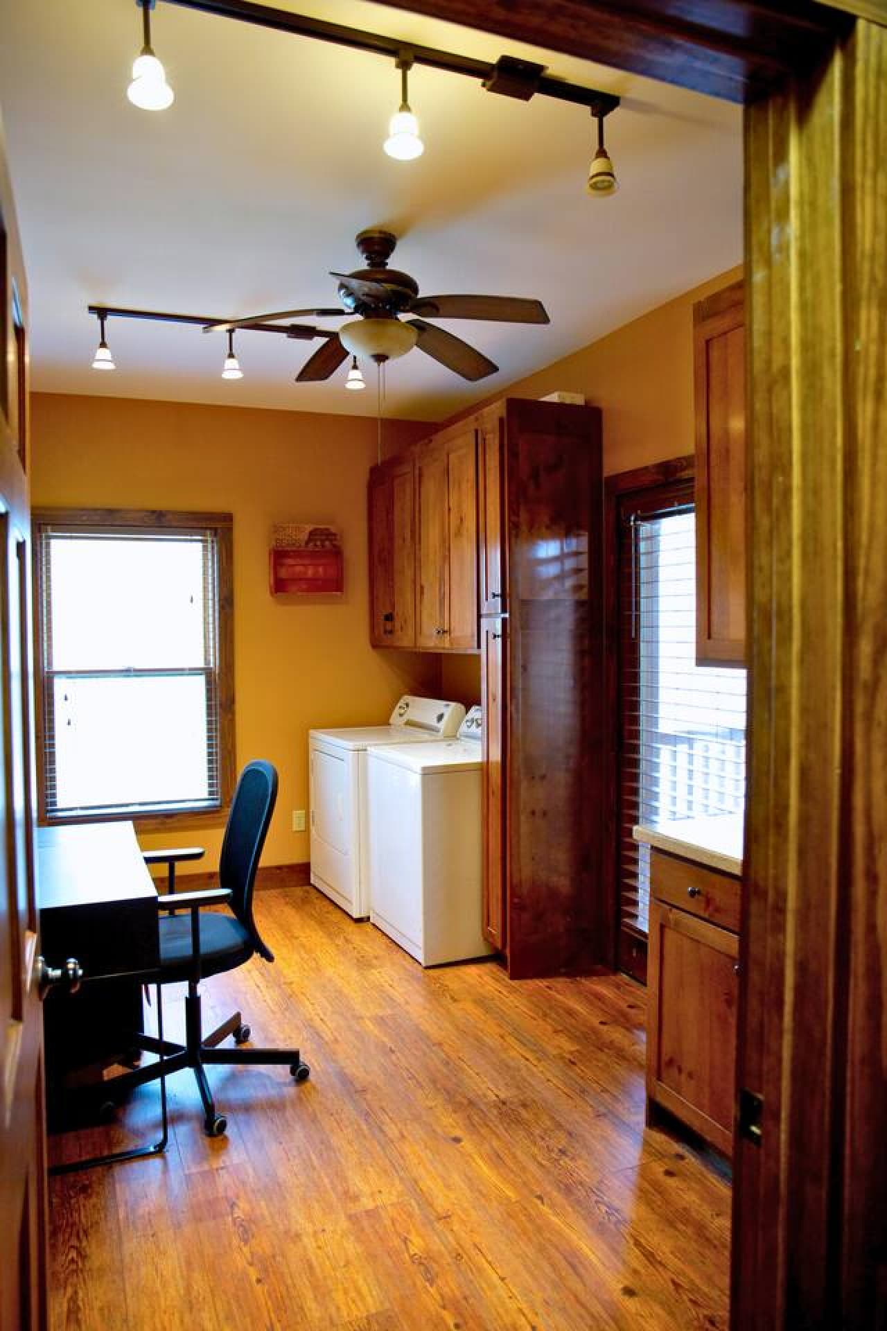 The laundry area doubles as a work space, with a door that leads directly to the screened-in porch—perfect for stepping out and enjoying the fresh air during breaks.