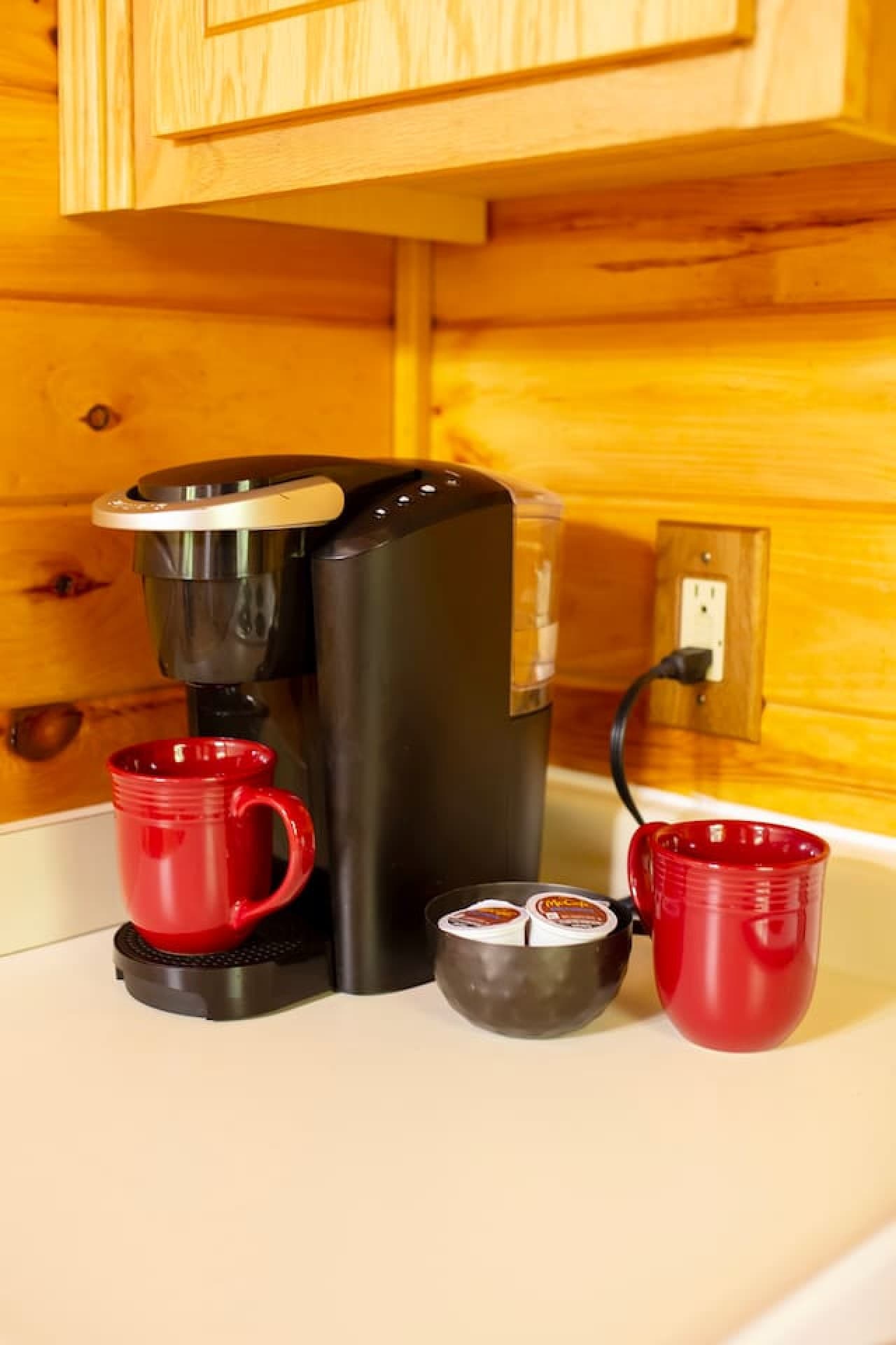 Keurig coffee maker with a starter kit, including 2 K-Cups, cream, and sugar to kickstart your first morning at Walden Cabin.