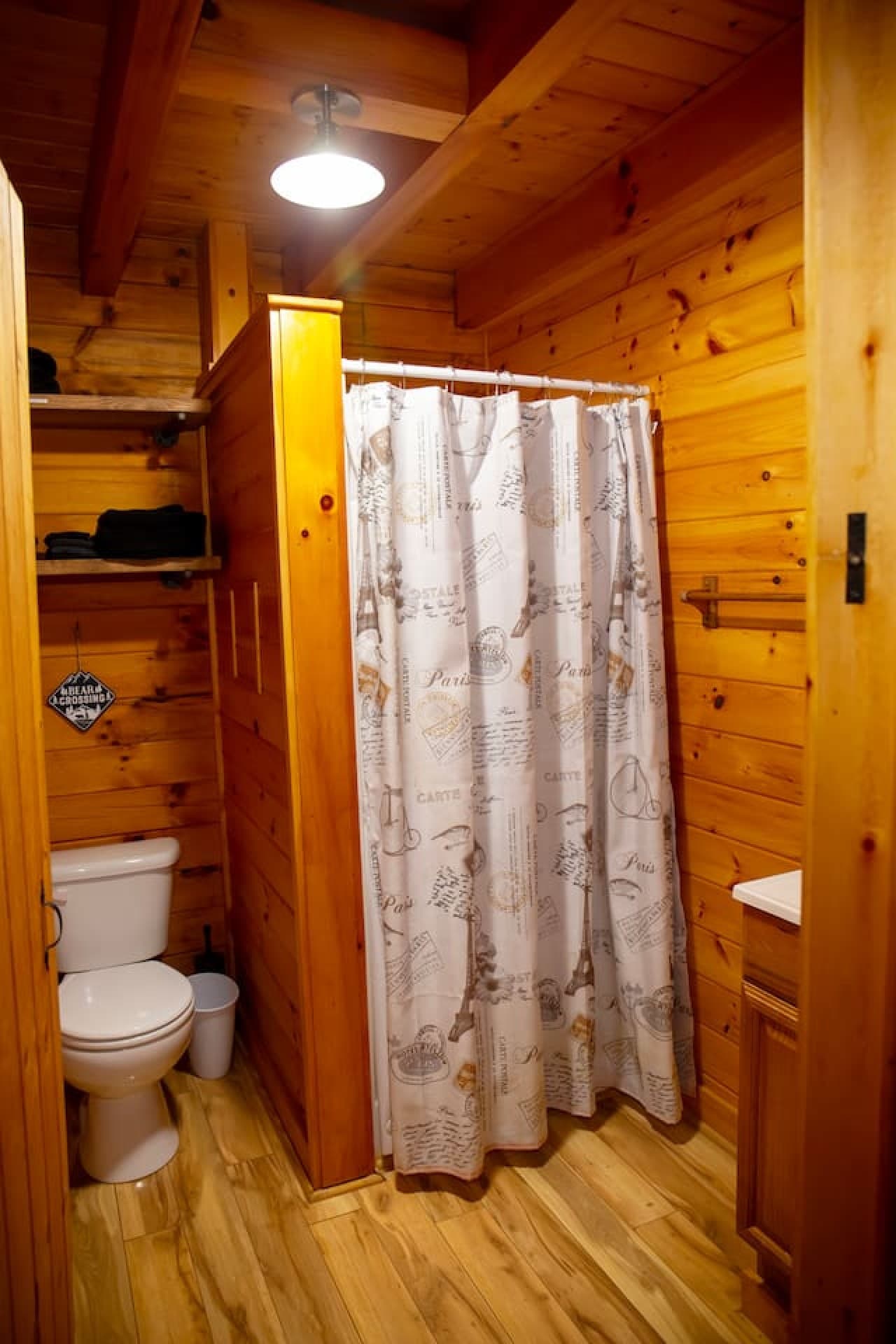 Full bathroom on the main floor with shower, shampoo, conditioner, body wash, towels, washcloths, toilet, and vanity. Two rolls of toilet paper provided.