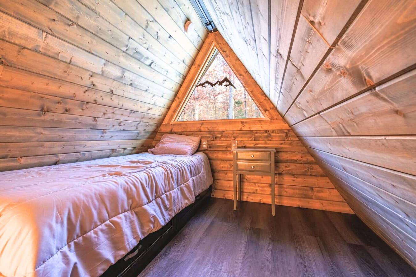 The loft serves as Bedroom 2, featuring a cozy single bed for a restful retreat.
