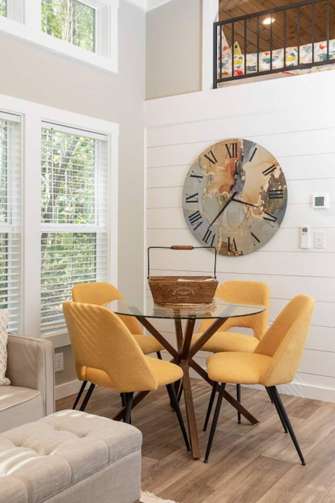 Dining area with seating for four, perfect for meals or remote work with a laptop-friendly setup.