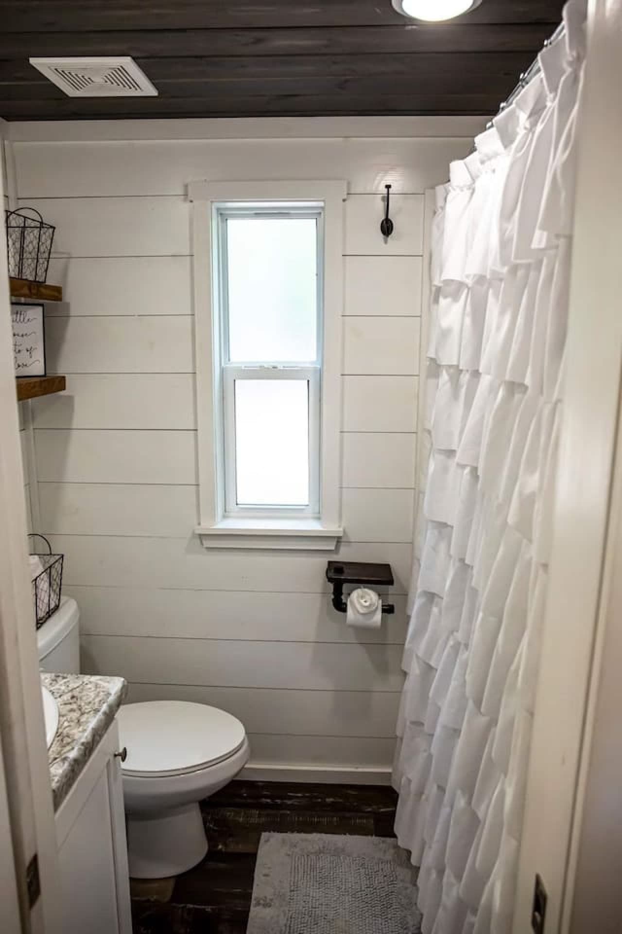 A simple, minimal full bathroom with fresh, bright finishes.