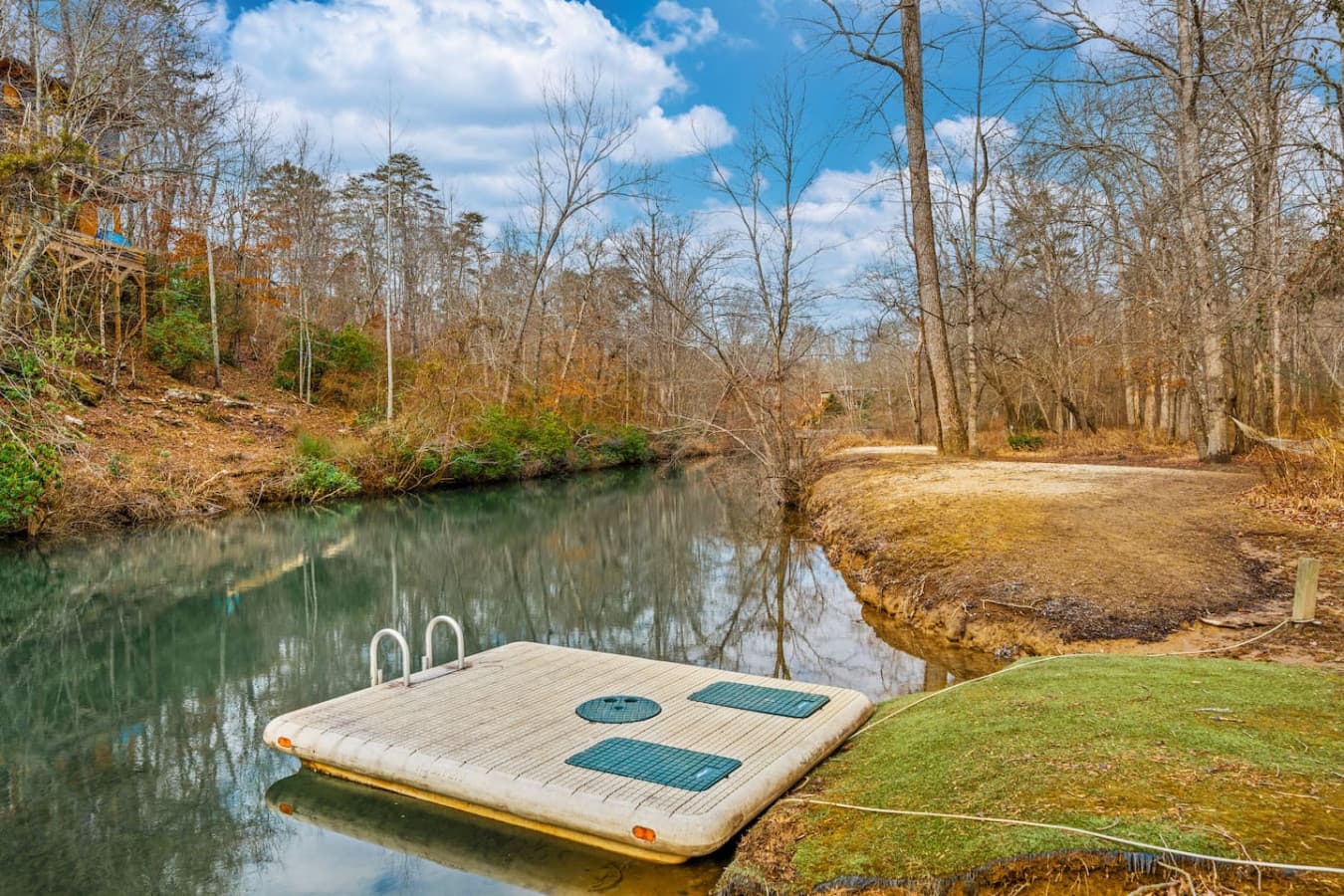 A peaceful spot to unwind, dip your toes in, or simply enjoy the stillness of the water surrounded by trees.