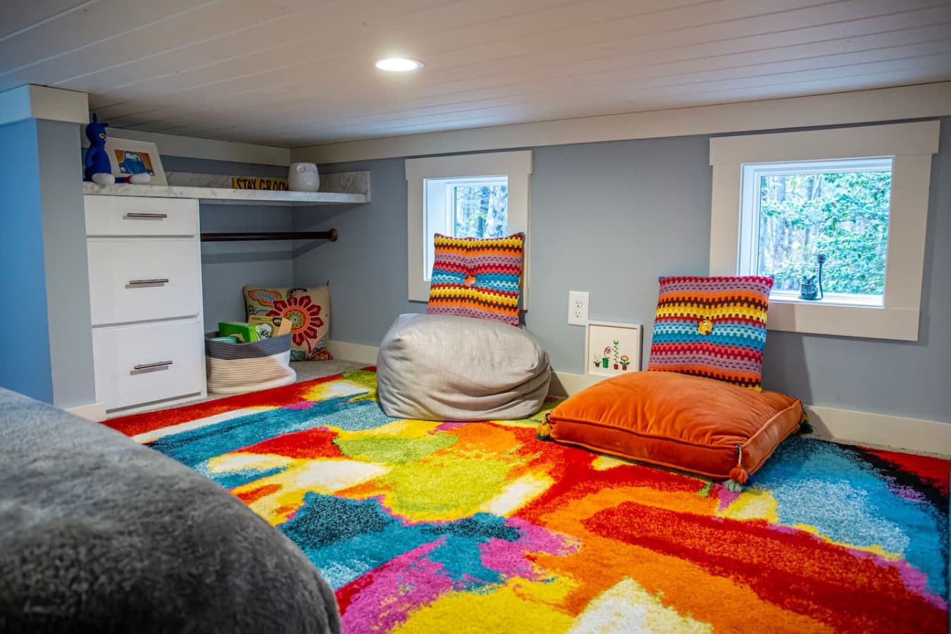 This vibrant corner of the loft is perfect for lounging or playing, with cozy bean bags and colorful pillows adding a fun, inviting touch.