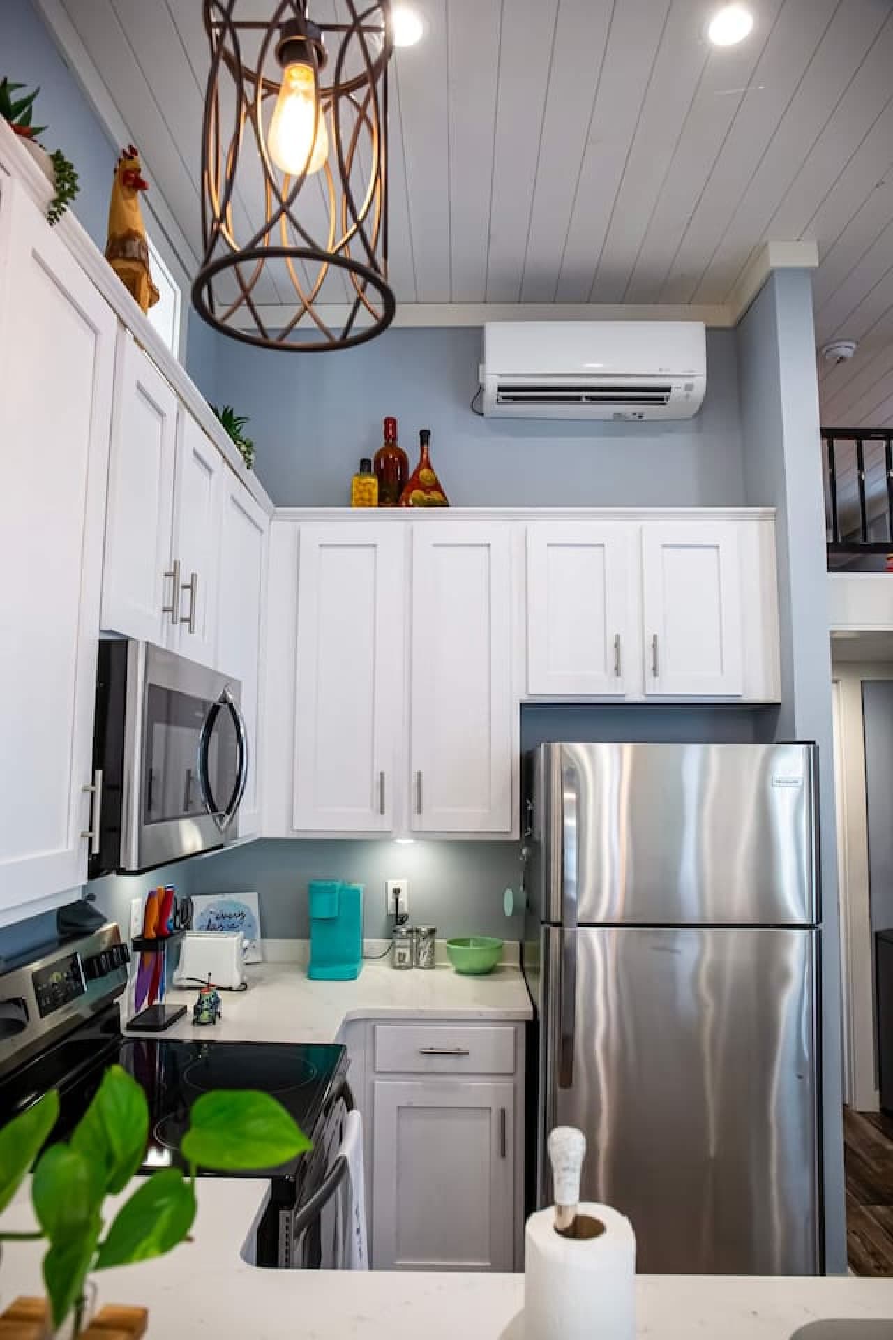 The unique light fixture and playful touches like the rooster figurine complete the homey, welcoming feel.