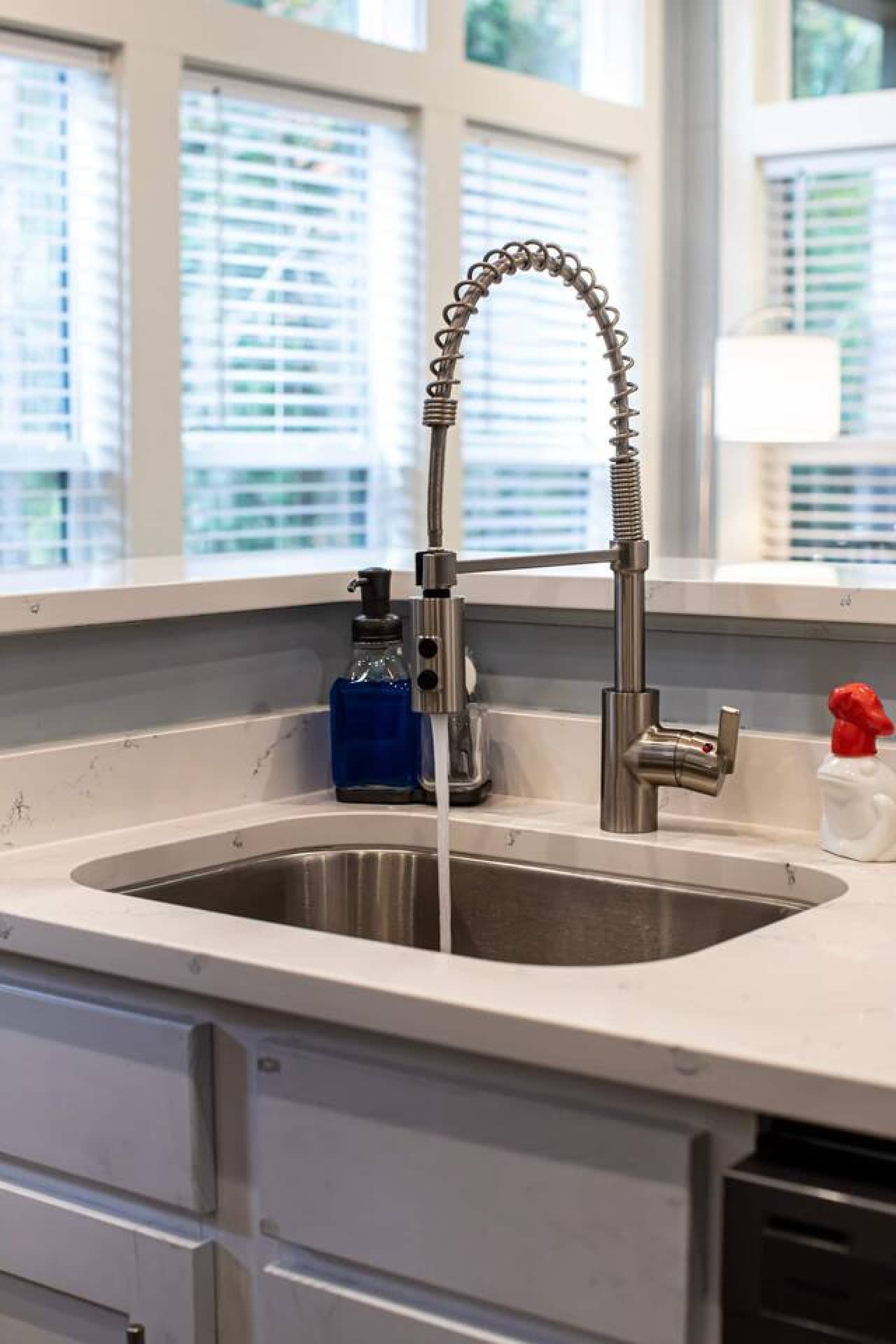 Sleek and functional, featuring a modern faucet with a flexible sprayer, perfect for cleaning up after meals or prepping ingredients.