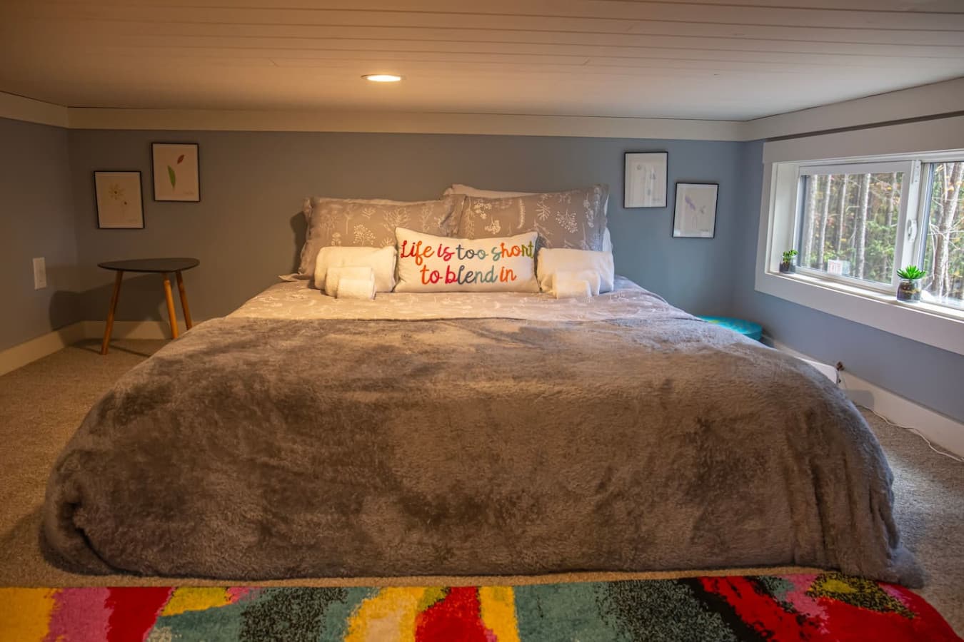 This loft bedroom is a playful and cozy retreat, with vibrant touches.
