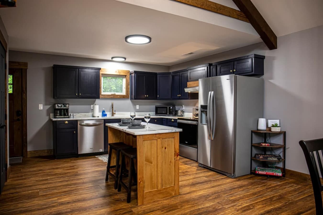Modern kitchen: Electric Stove and Oven, Coffee Maker (Drip & K-Cup), and a center island with seating for two.