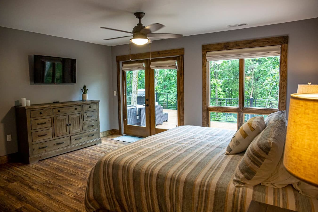 Bedroom 1 (Master) with stunning forest views, king bed, Smart TV, and ensuite bathroom for added comfort.