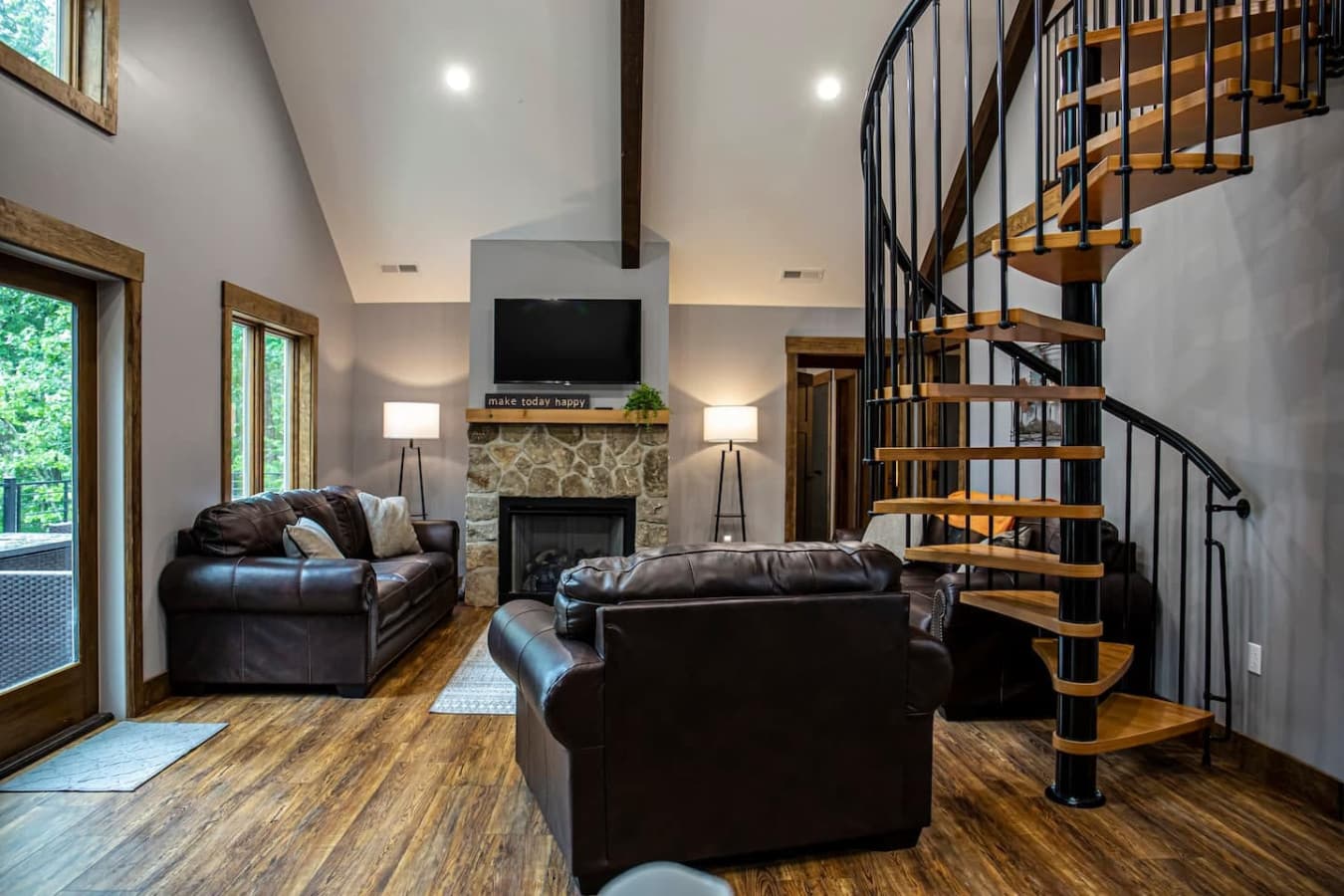Living Room with Gas Fireplace and Cozy Seating. Spiral Staircase Leads to Bedroom 3.