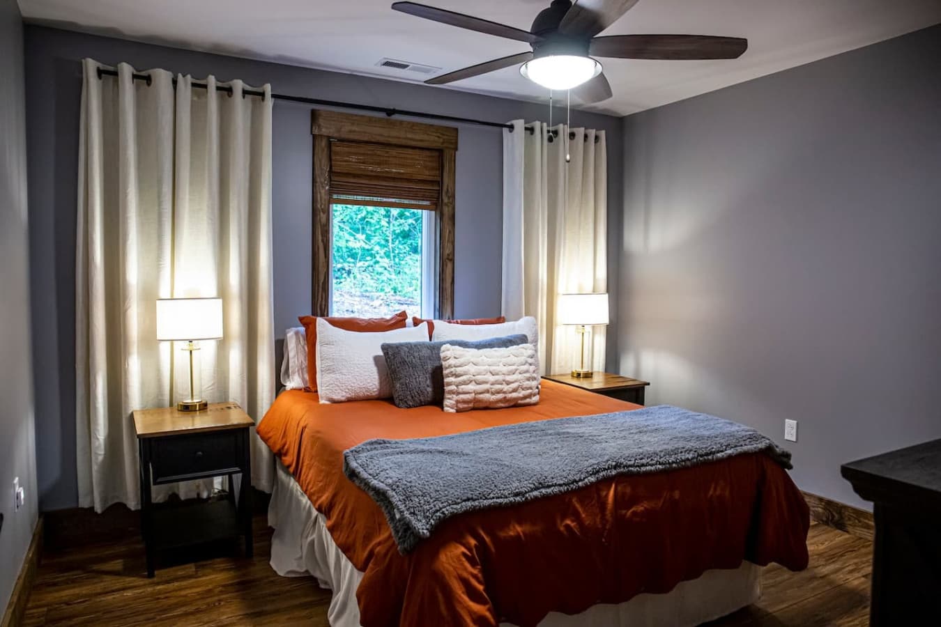 Bedroom 2 with a cozy queen bed, warm lighting, and soft linens for a comfortable night’s rest.