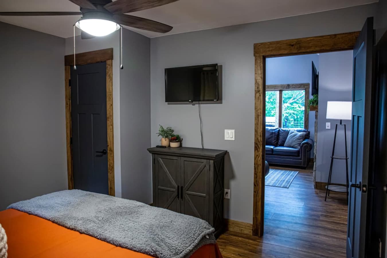 Bedroom 2 with Queen Bed, Smart TV, and ample storage including a closet and dresser.