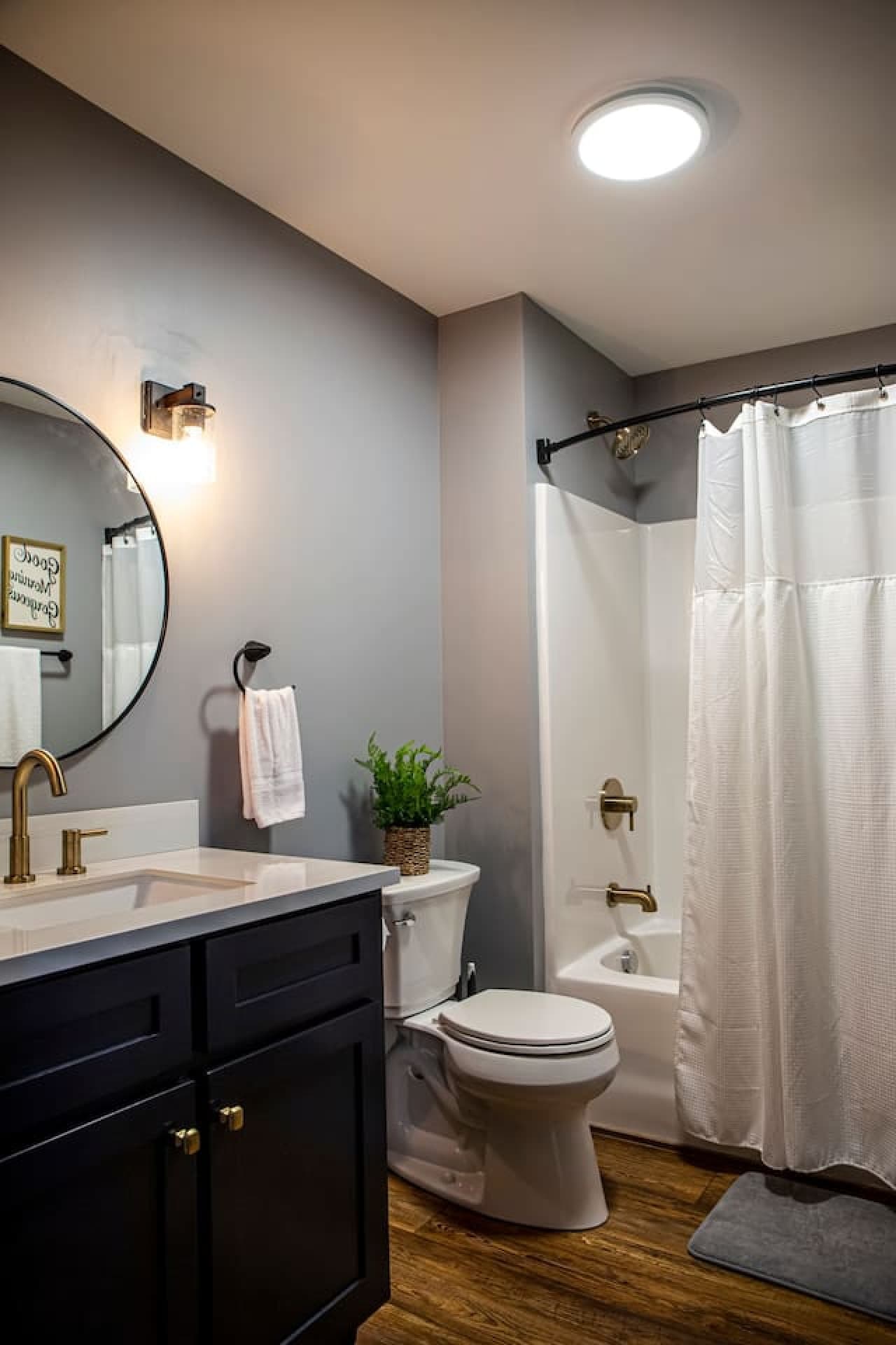 Bathroom 2 with modern vanity, gold fixtures, toilet, and tub/shower combo.
- 2 Toilet Paper Rolls
- 1 Towel & Washcloth Per Guest