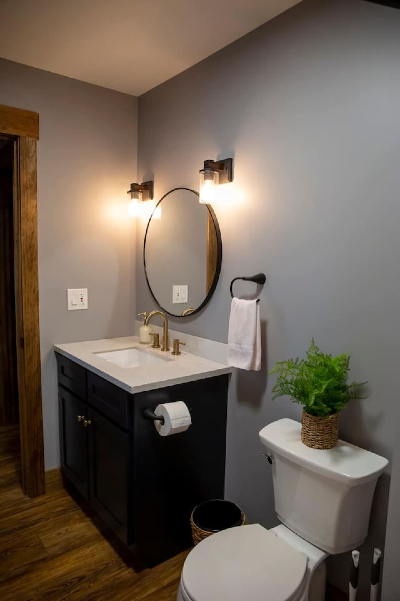 Bathroom 2 with modern vanity, gold fixtures, toilet, and a convenient tub/shower combo.