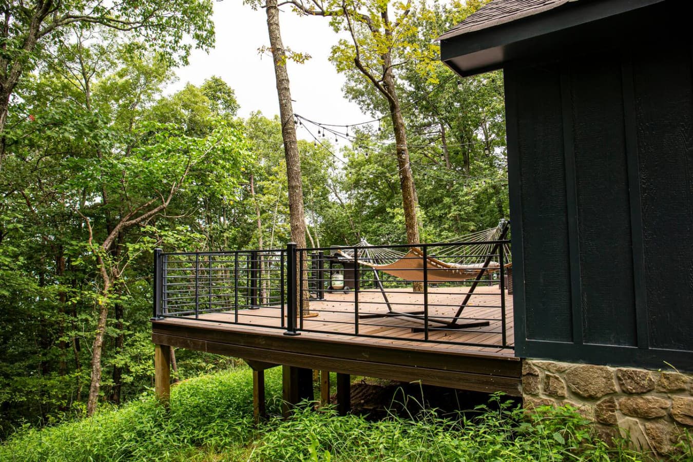 Spacious back deck with string lights and a relaxing hammock—ideal for unwinding under the stars.