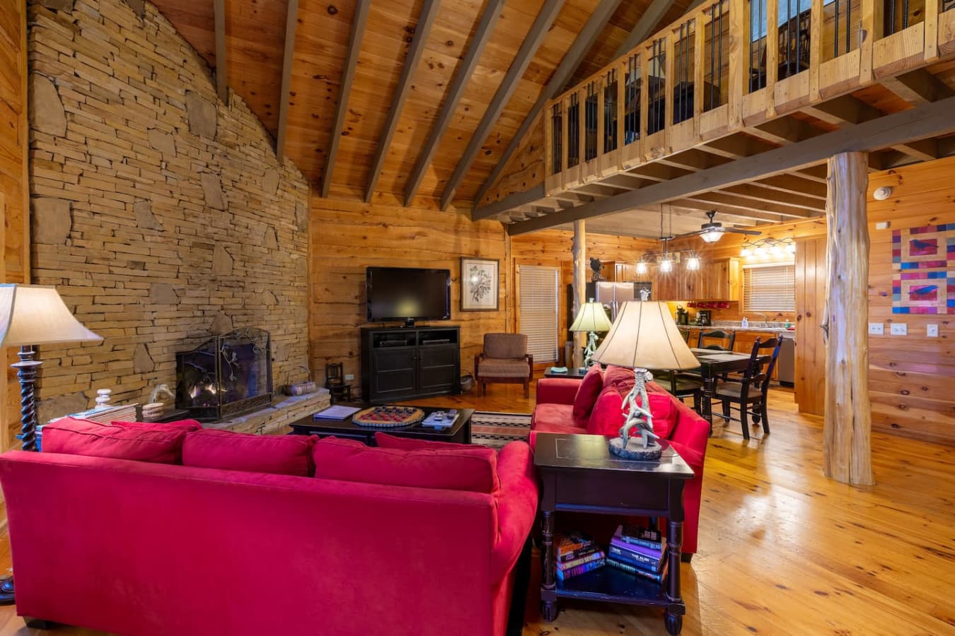 Living room with TV, fireplace, and plenty of comfortable seating.