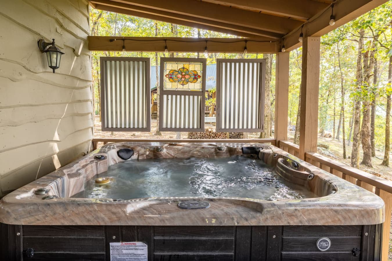Large hot tub on the covered back porch overlooking the valley and mountains.
