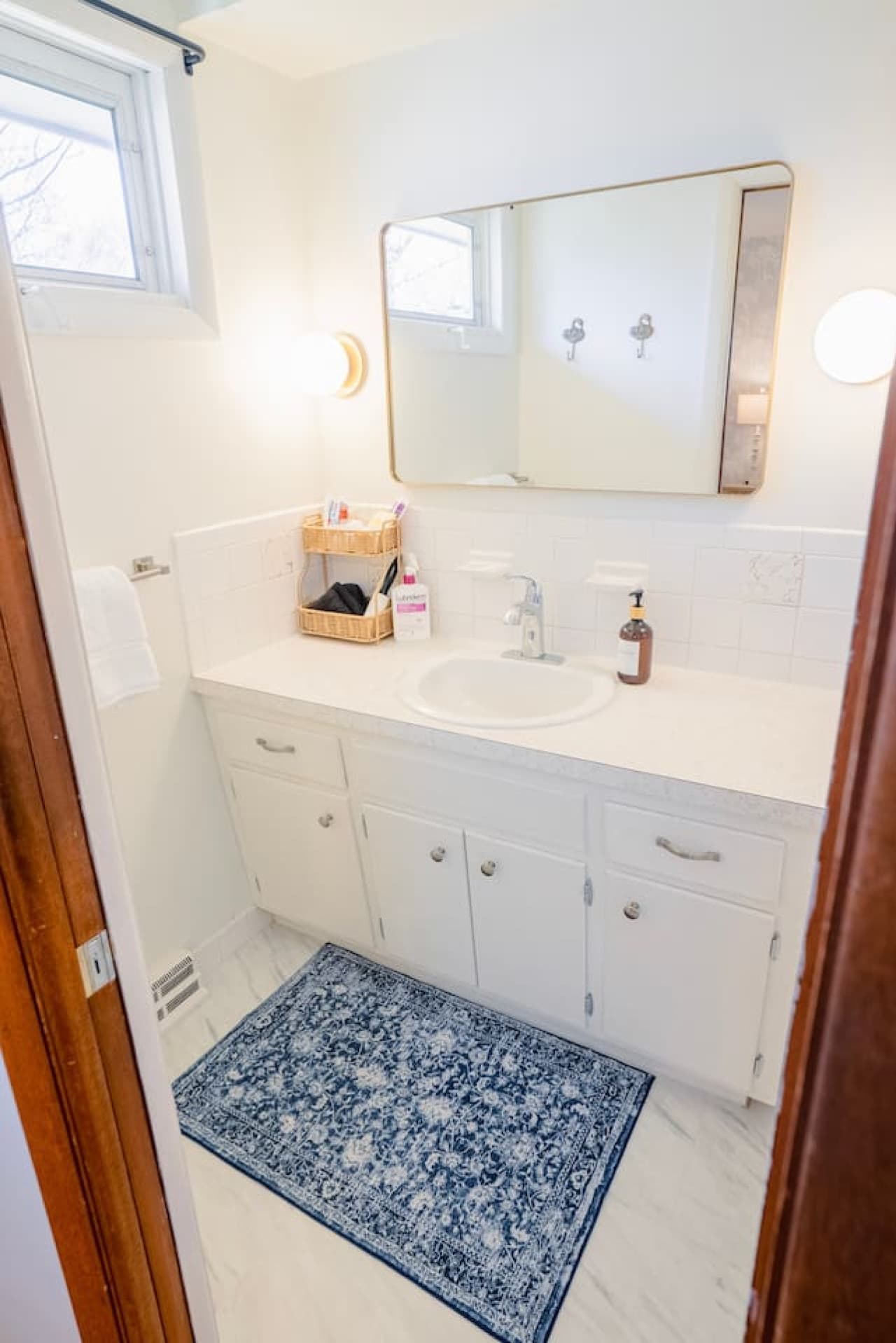 Sink area with counter space for personal items.