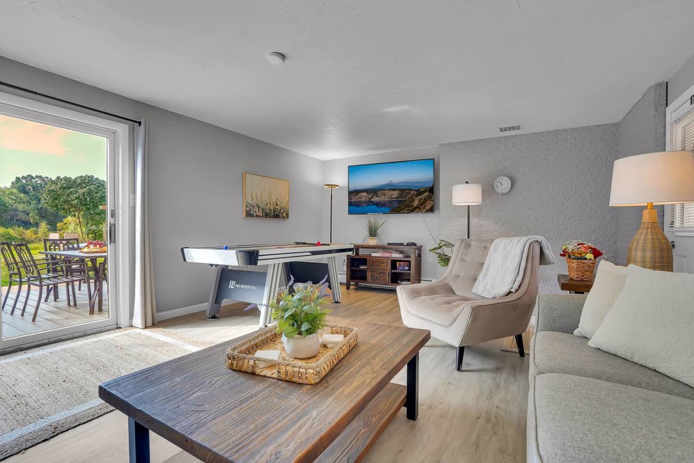 A cozy yet spacious living room with large windows, creating a sun-filled retreat for casual gatherings or peaceful moments.