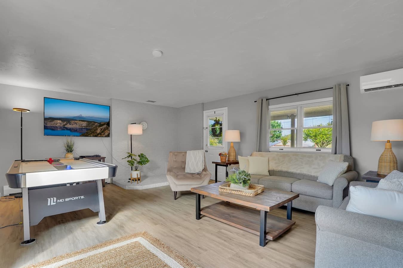 Featuring plush furniture and plenty of windows, this living room is designed for both comfort and relaxation.