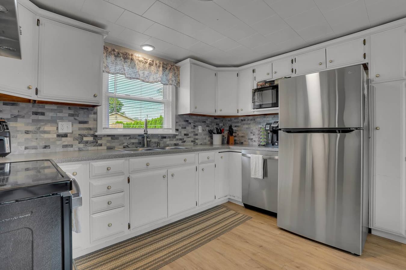 A clean and inviting kitchen with ample natural light, designed for both convenience and comfort while cooking.
