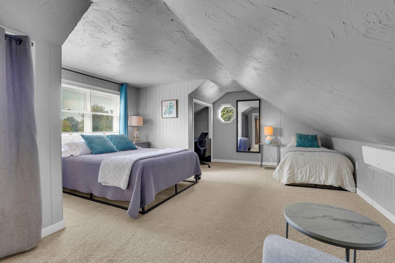 A bright room with two plush beds, ideal for those traveling together, providing ample space and comfort for a restful stay.
