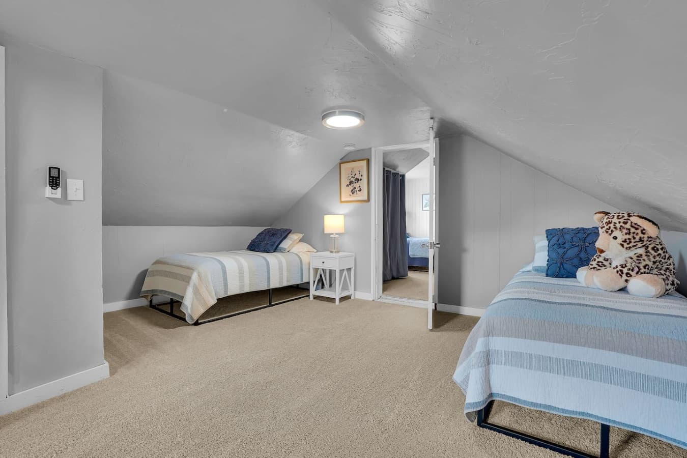 A well-lit room with three single beds, offering flexibility and comfort for those traveling together or in need of separate sleeping spaces.