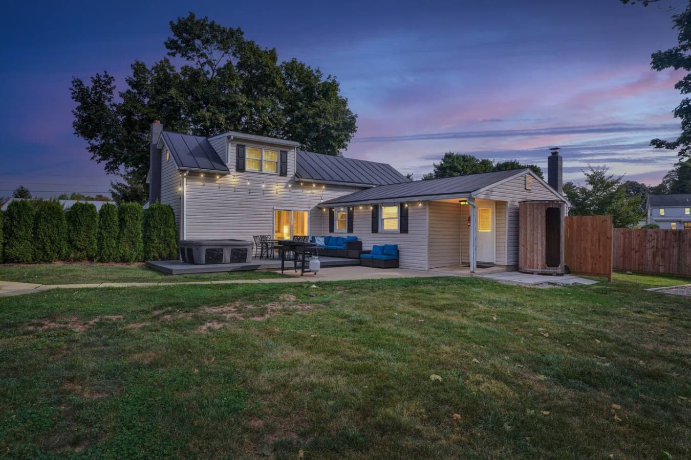 Enjoy the privacy of a fenced-in area and the warm glow from the home's windows as the sun sets.