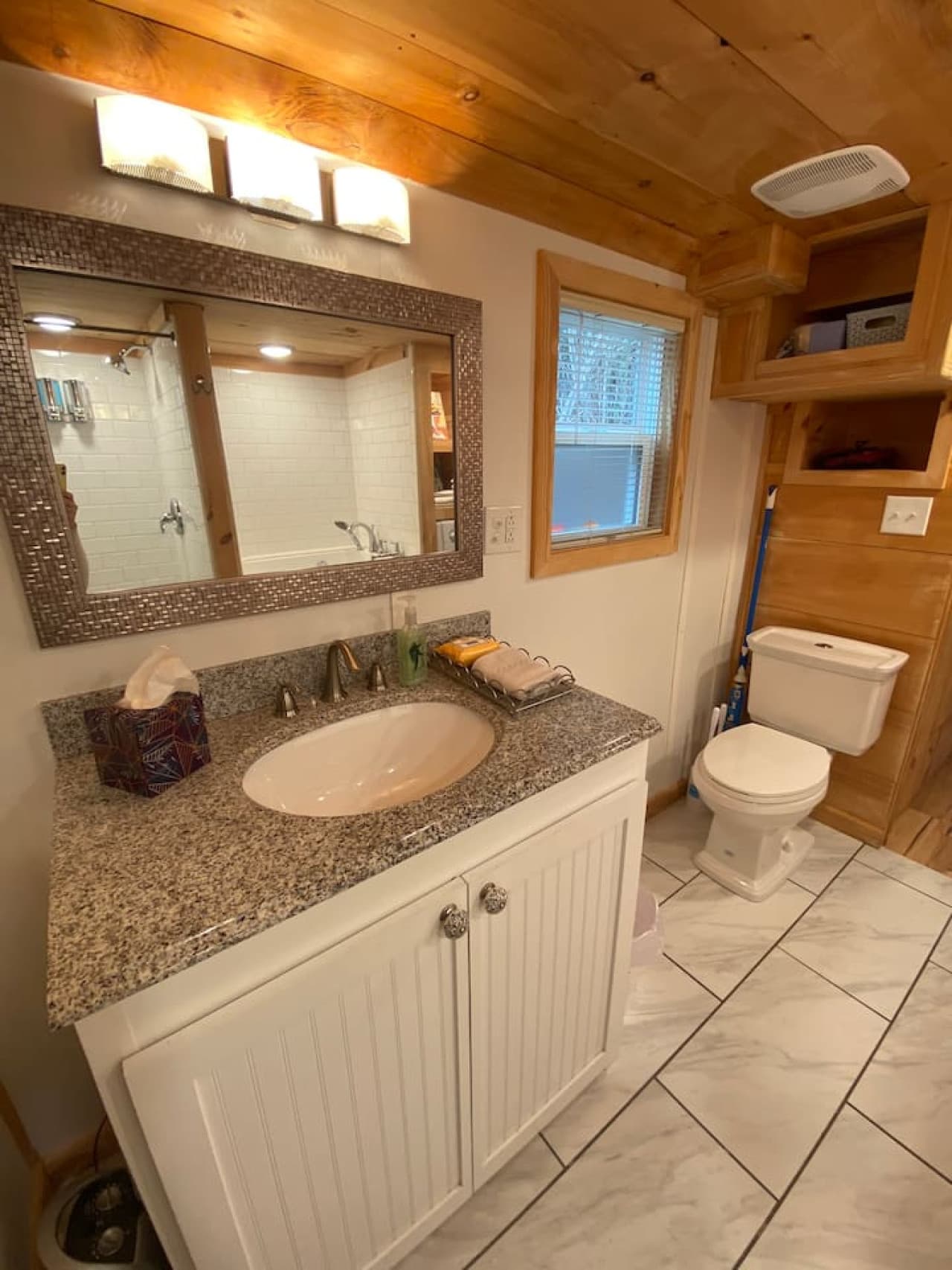 A well-appointed vanity and toilet for your convenience.