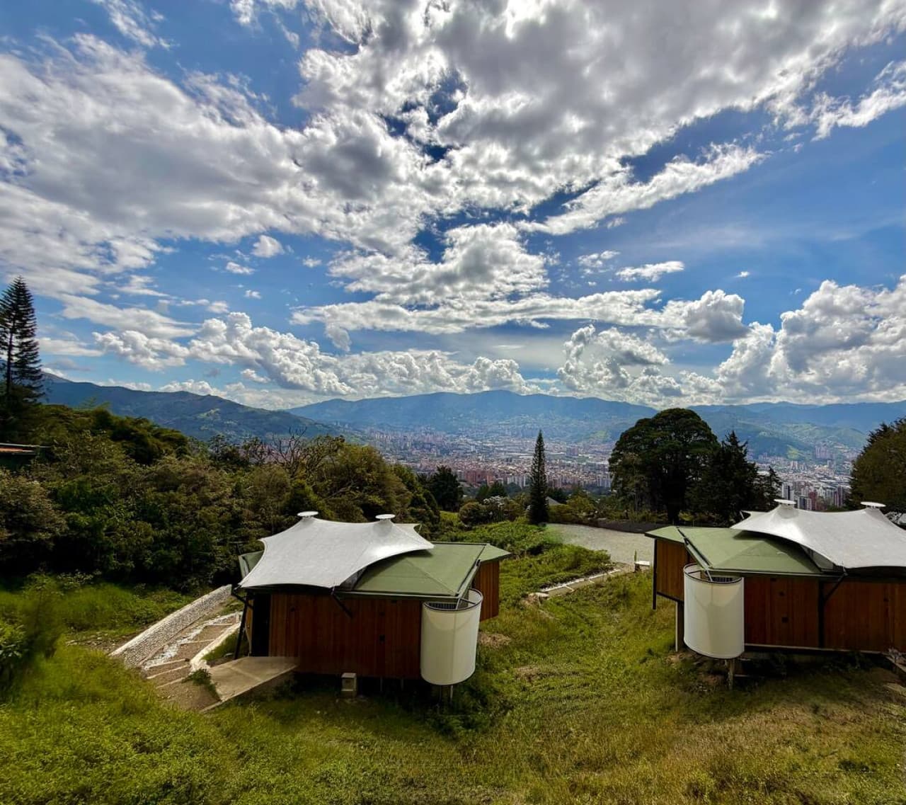 Set within a boutique collection of cabins, surrounded by greenery and skyline views.