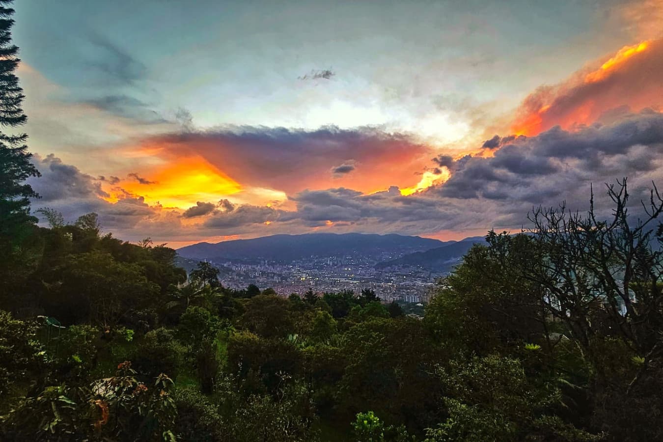 Front-row seats to Medellín’s sunsets, where vibrant skies meet twinkling city lights.