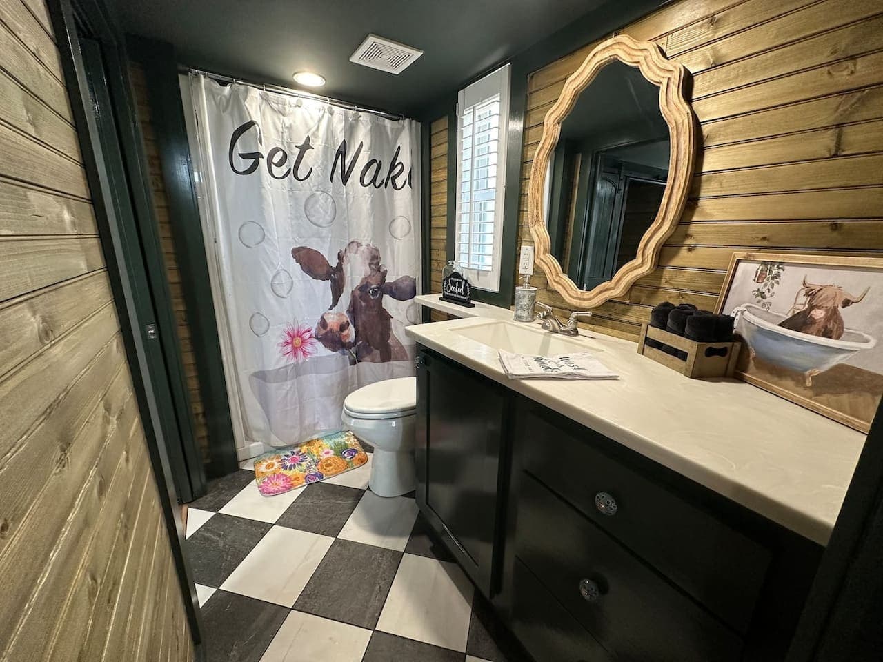 The recently renovated bathroom features a shower. It has two entrances: one from the master bedroom and another from the living room.