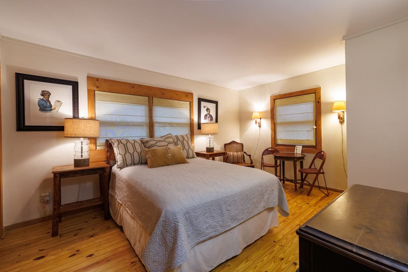 A comfortable queen bed and a small table — perfect for working from home or planning your next adventure.