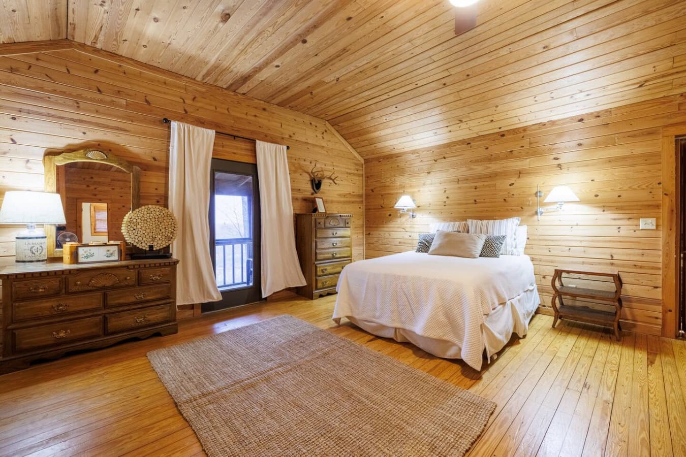 Wake up to warm natural light filtering through soft curtains — this bright bedroom offers peaceful views and cozy comfort.