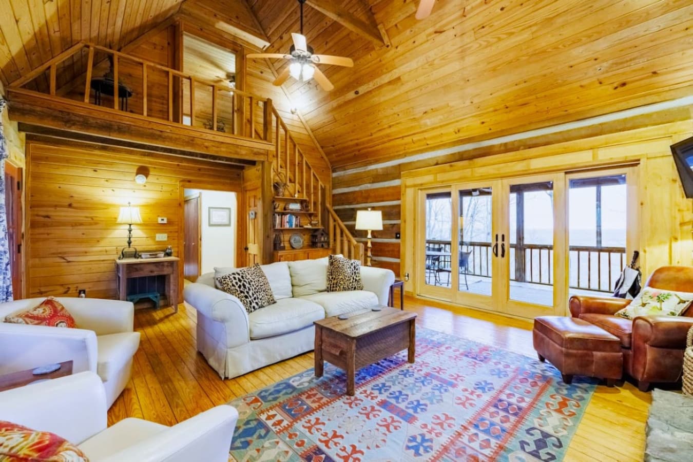 The living room offers beautiful views from every seat, with sliding glass doors that open to a screened-in back porch.