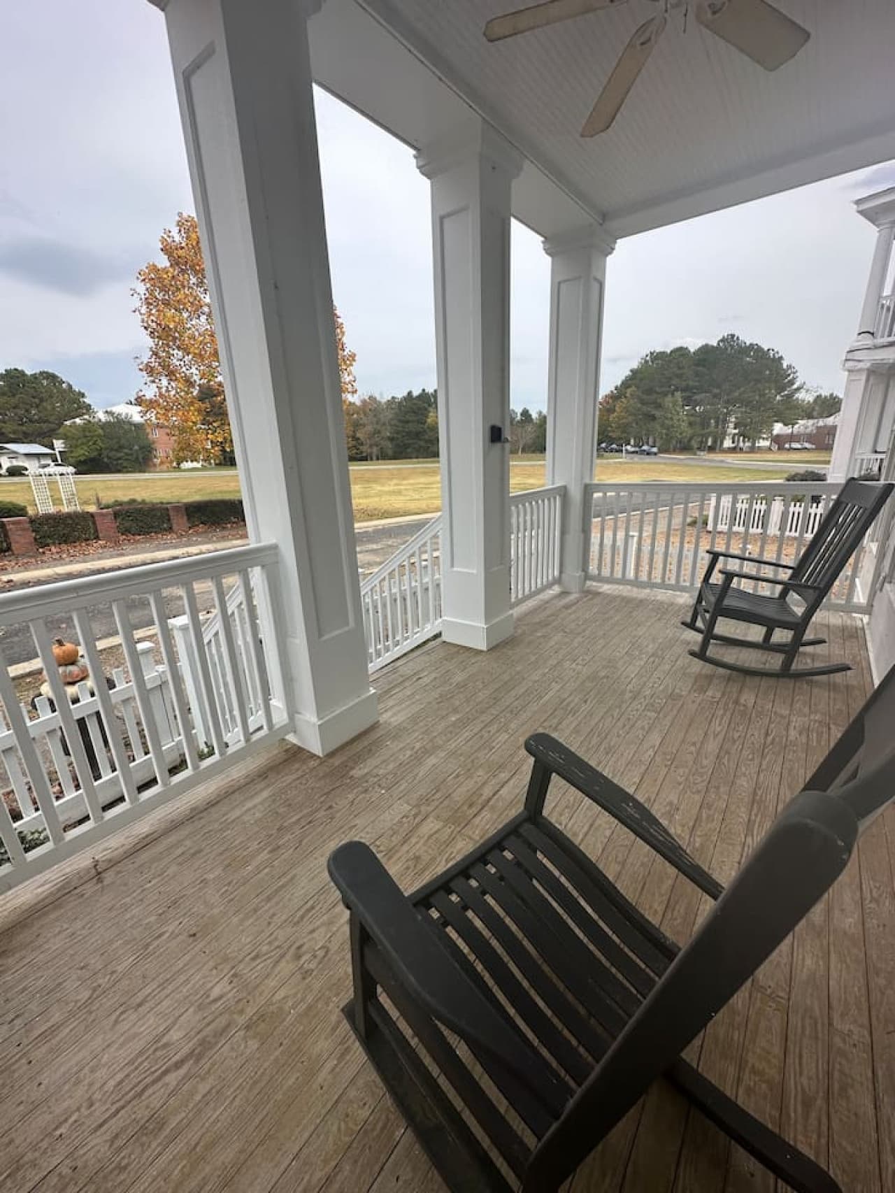 Front porch with two rocking chairs and views of fall colors changing.