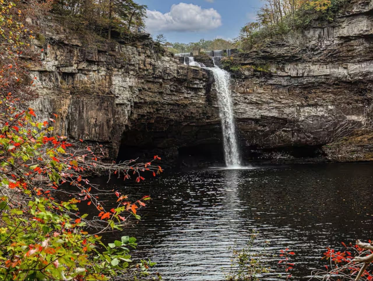 DeSoto Falls, a stunning 104-foot waterfall in DeSoto State Park, perfect for hiking, picnicking, and capturing beautiful photos of cascading water.