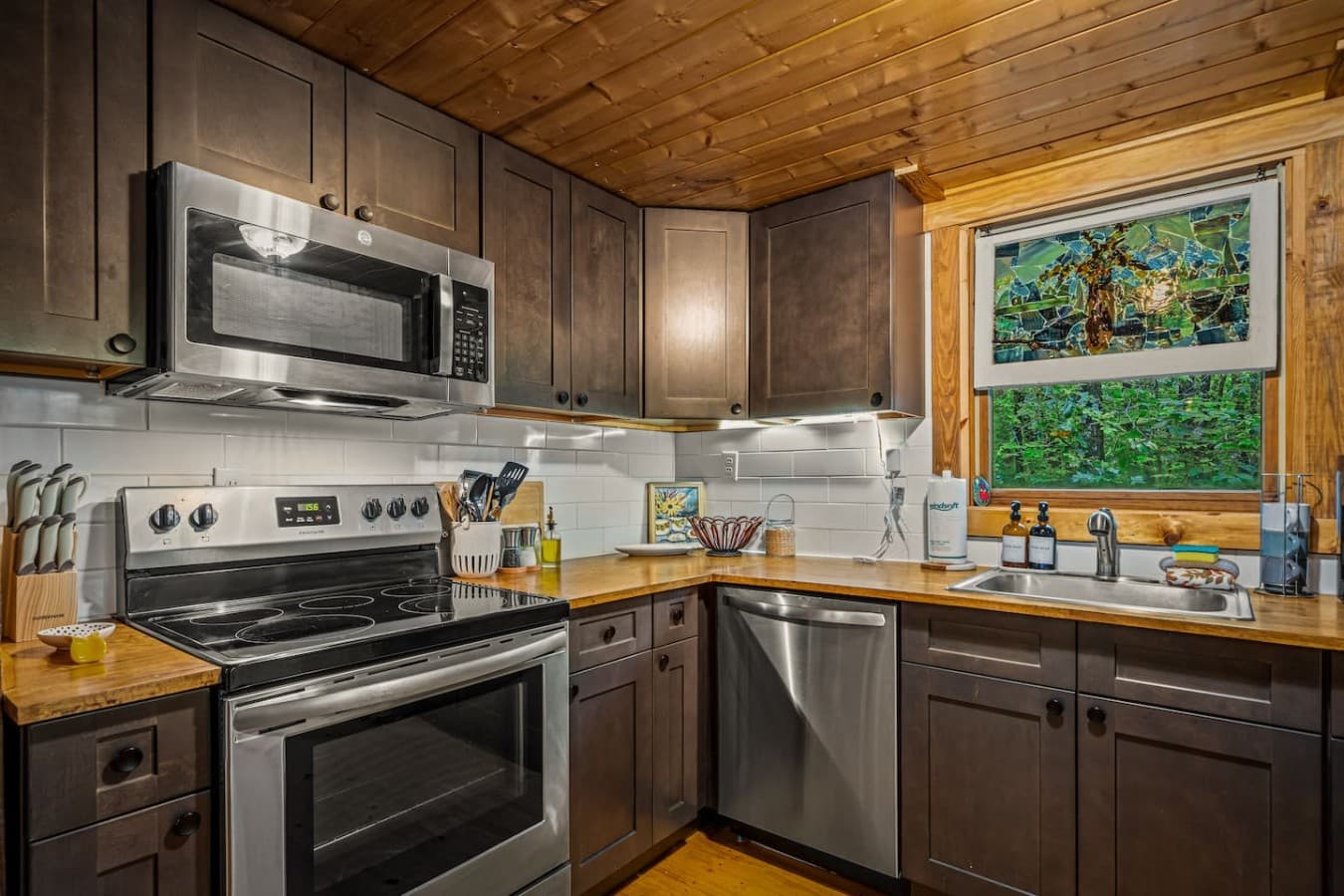 Stocked kitchen with stainless steel appliances.