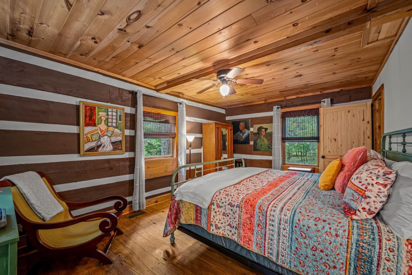 Spacious master bedroom offering a king bed, armoire, full bath, and French doors to the covered back porch.