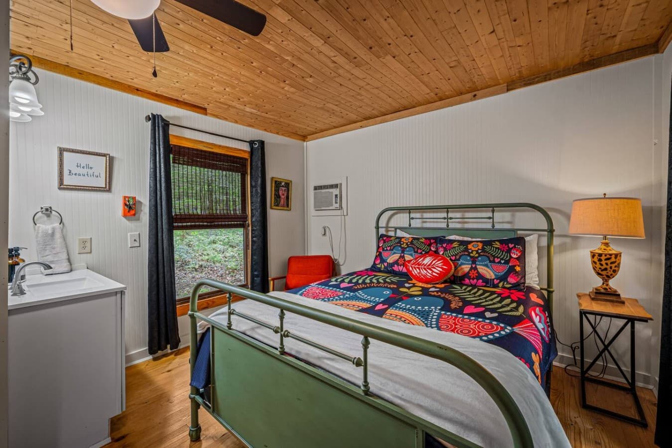 The Logged Out! This second bedroom features a comfortable queen bed and warm, relaxing vibes.
