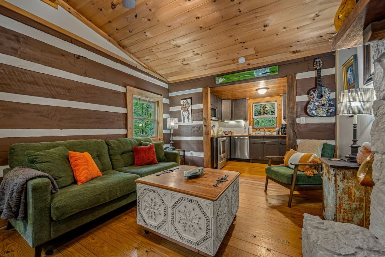 Whether you're sipping coffee by the fireplace, lounging under string lights on the porch, or exploring nearby trails, this cabin offers a memorable getaway with personality.