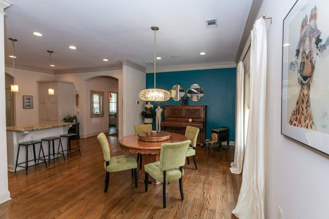 Dining space with extra seating at the adjacent kitchen bar.