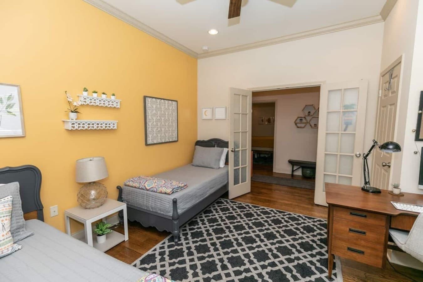 Comfortable sleeping space with a practical work setup.