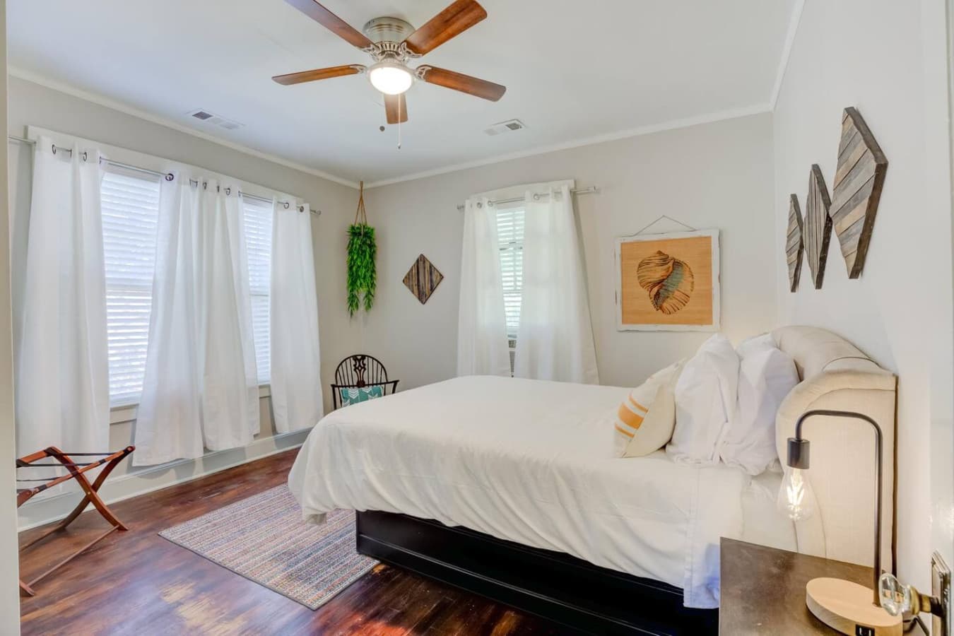 Bright queen bedroom with soft light and easy, calming vibes.