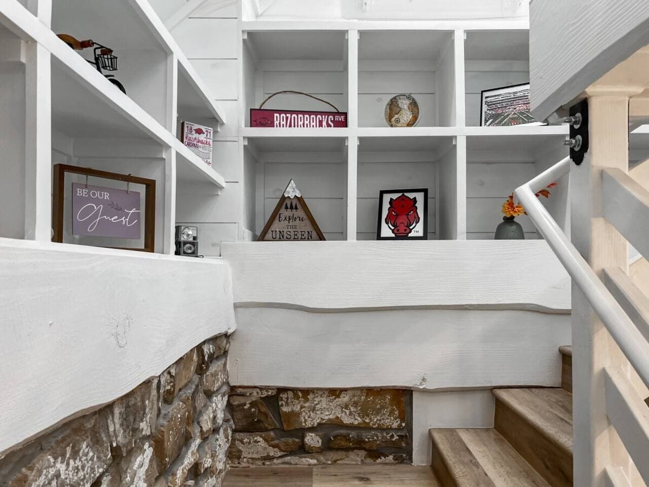 Take the creative Go Razorbacks staircase up to the queen loft bedroom.