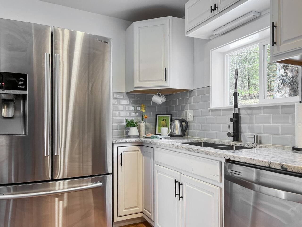 The kitchen has a suite of stainless steel appliances.