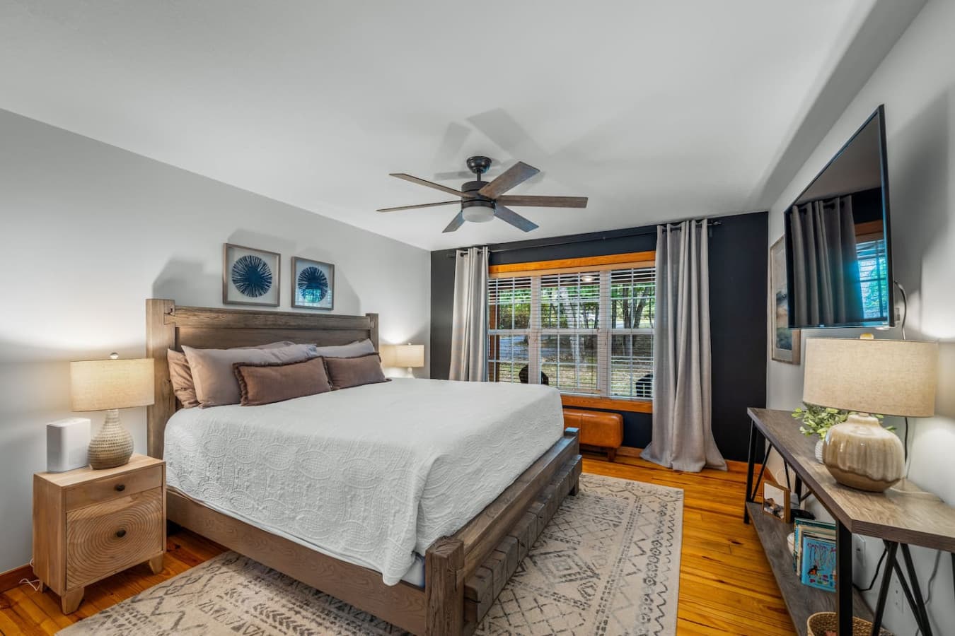 Master bedroom on the main floor with a king bed, attached full bath, and Smart TV for your comfort and convenience.