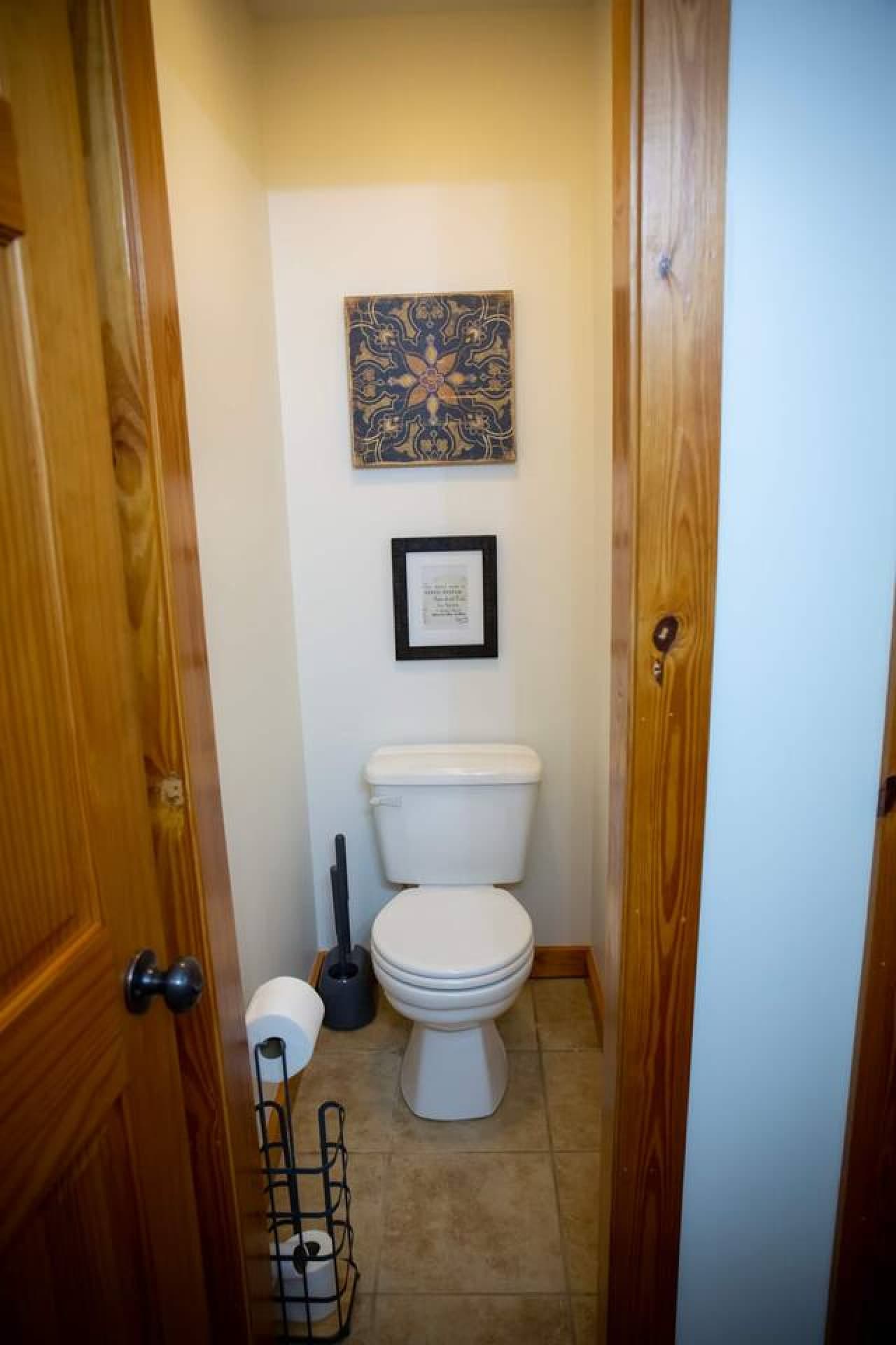 Half bathroom with a convenient toilet closet for added privacy.