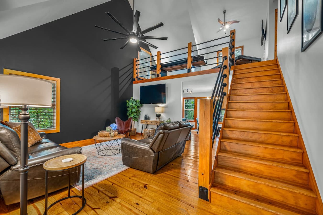 Cozy up in the living room with a Smart TV for your entertainment. Stairs up to the 2nd floor.